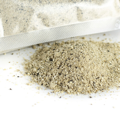 Trufo - Freeze Dried Truffle Powder spilled from a transparent vacuum-sealed pouch onto a white surface, showcasing its fine, dry texture